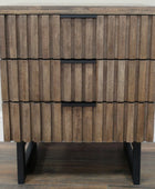 Wooden side table with a striped pattern and black legs on a wooden floor.