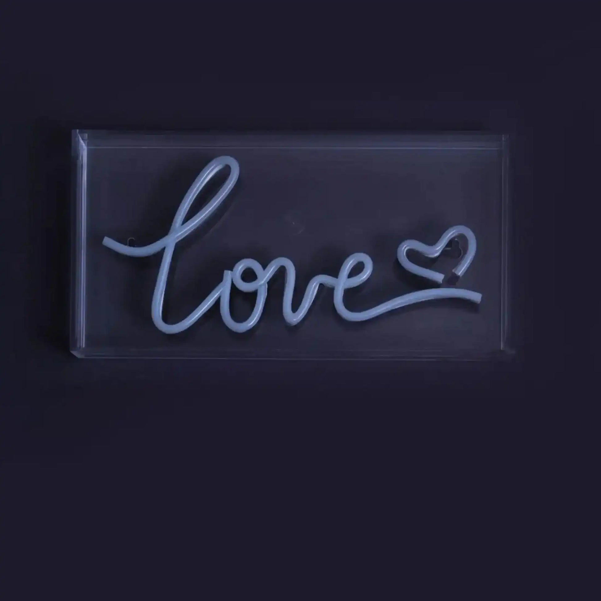 Neon sign with the word 'love' on a black background