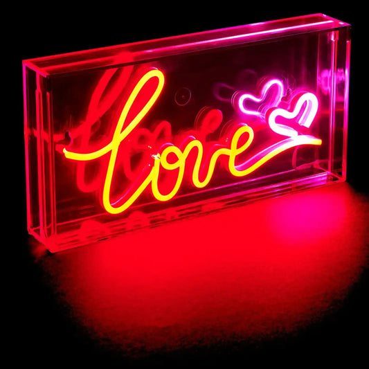 Neon sign with the word 'love' and heart symbols on a black background