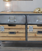 Wooden dresser with metal drawers and wheels on a wooden floor.