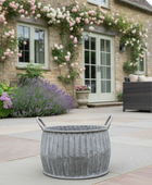 Decorative outdoor setting with a stone building, flowers, and a gray planter.