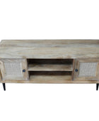 Wooden TV stand with rattan doors on a wooden floor against a gray wall.