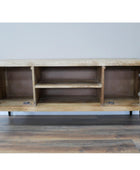 Wooden cabinet with open doors on a wooden floor against a light gray wall