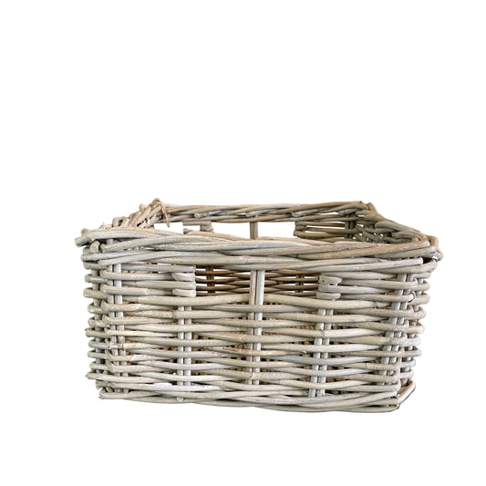 Wicker basket on a dark surface with a neutral background