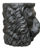 Black ram head sculpture on a wooden surface