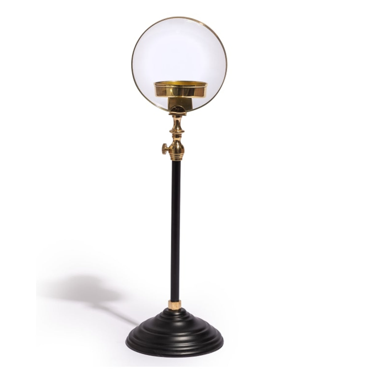 A vintage-style table lamp featuring a large, clear glass globe shade on a black metal stand with polished brass accents and a tiered circular base, set against a plain white background.