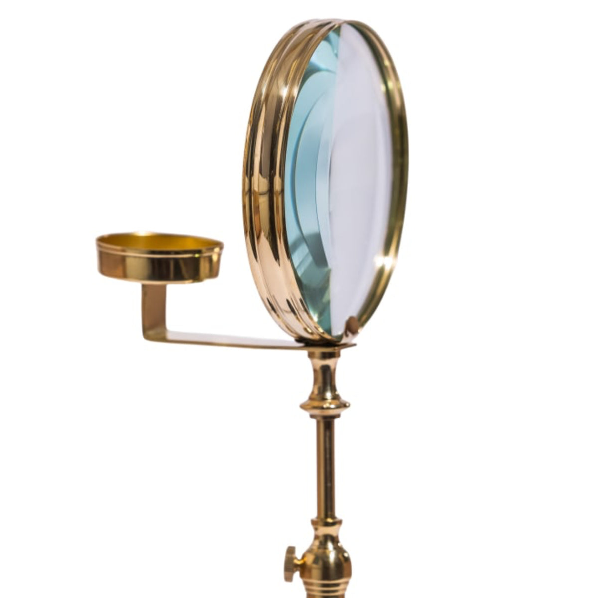 A brass magnifying mirror with an adjustable stand and a small brass cup holder on the side, shown against a plain white background.