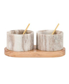 Two marble salt shakers with wooden stands on a white background