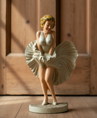Statue of a woman in a vintage outfit on a wooden floor