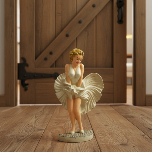 Statue of a woman in a white dress on a wooden floor with a wooden door in the background