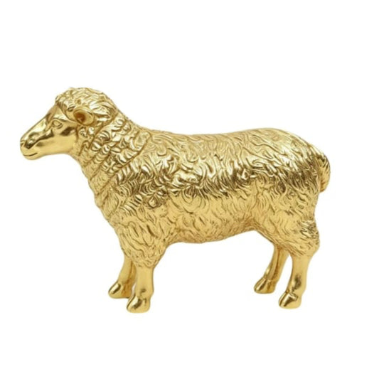 A polished gold-colored metal figurine of a sheep, showcasing detailed textured wool and a shiny, reflective finish, set against a plain white background.