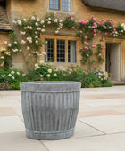 Decorative planter in front of a house with floral arches