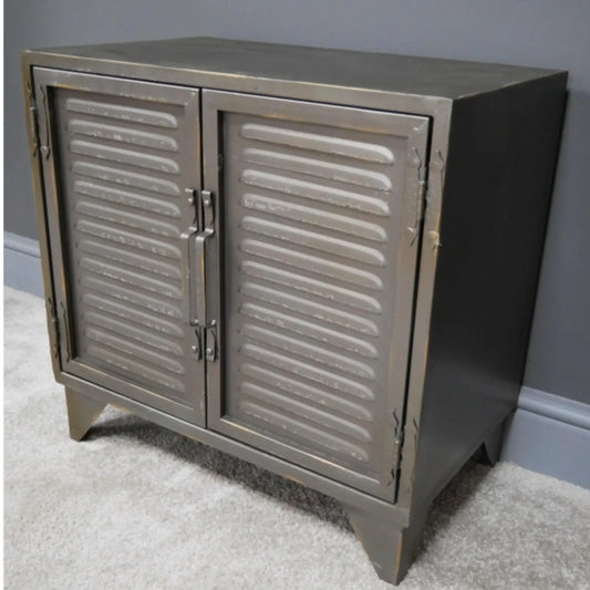 Metallic cabinet with shutter doors on a gray carpeted floor against a gray wall.