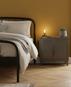 Bedroom with a bed, nightstand, and window.