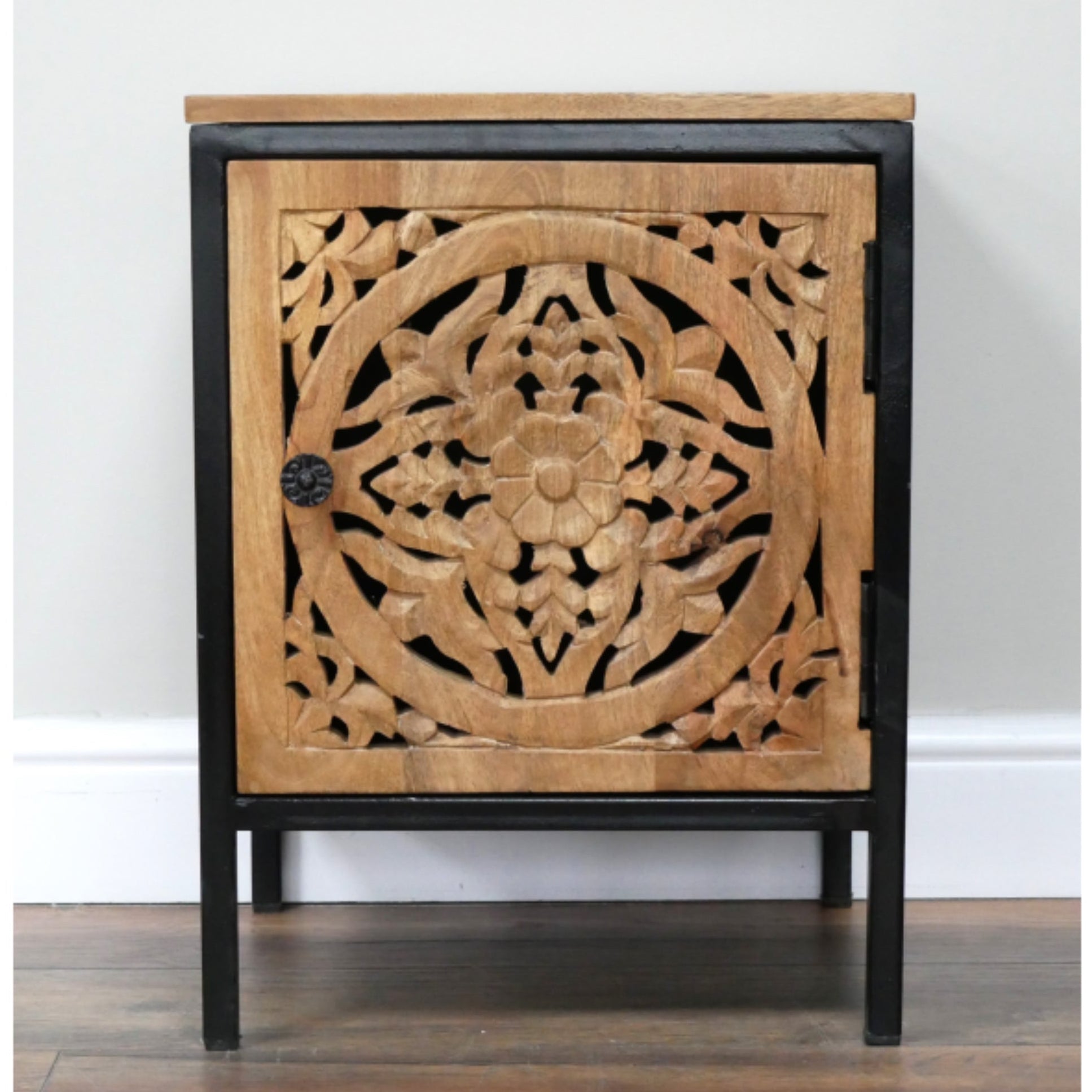 Wooden cabinet with intricate carvings on a white background