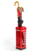 Red phone booth-shaped umbrella stand with a black umbrella inside on a white background
