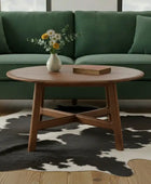 Wooden coffee table in front of a green sofa on a wooden floor
