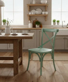Kitchen with wooden table and green chair, shelves with kitchenware, and a sink.