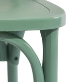 Close-up of a green metal chair with a white background