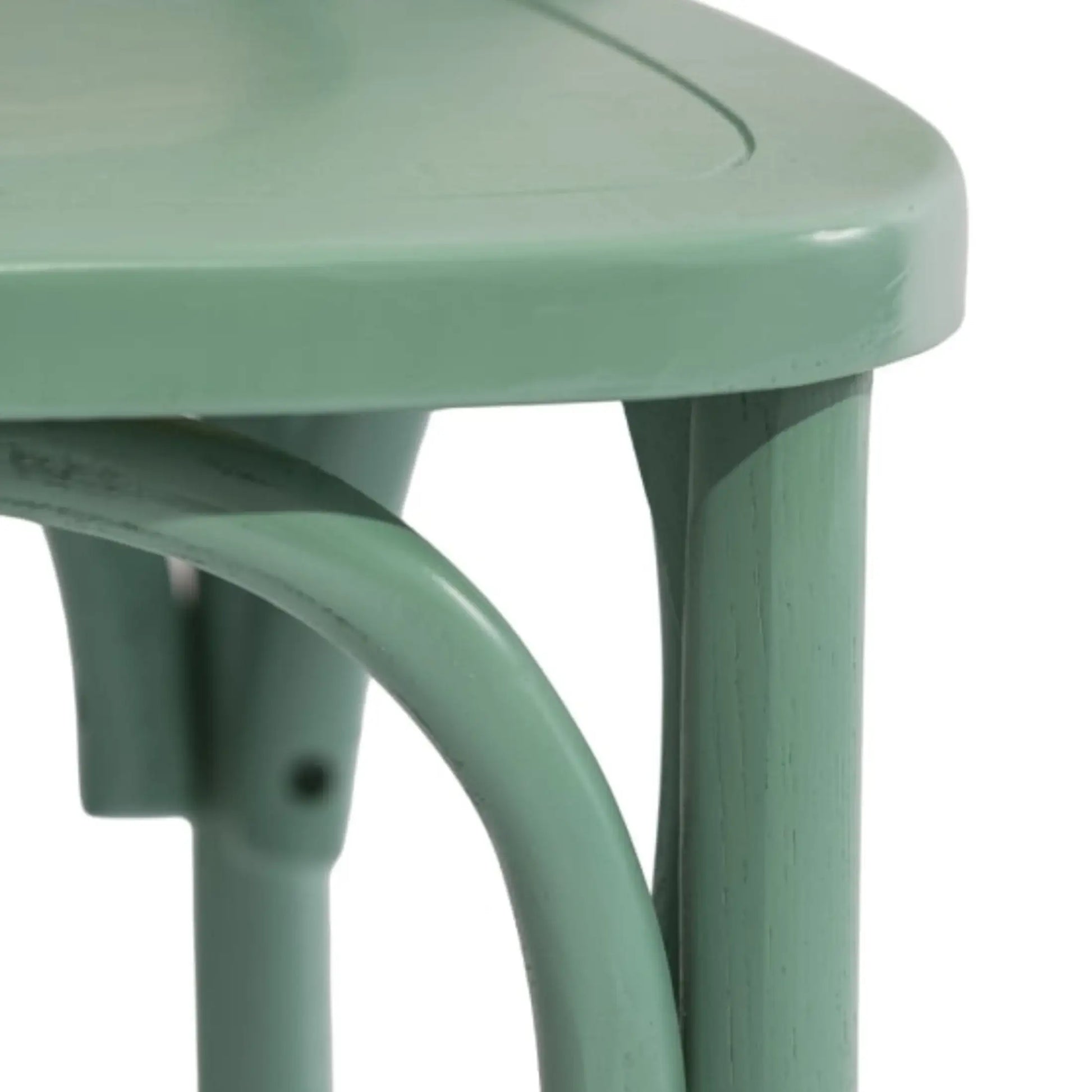 Close-up of a green metal chair with a white background