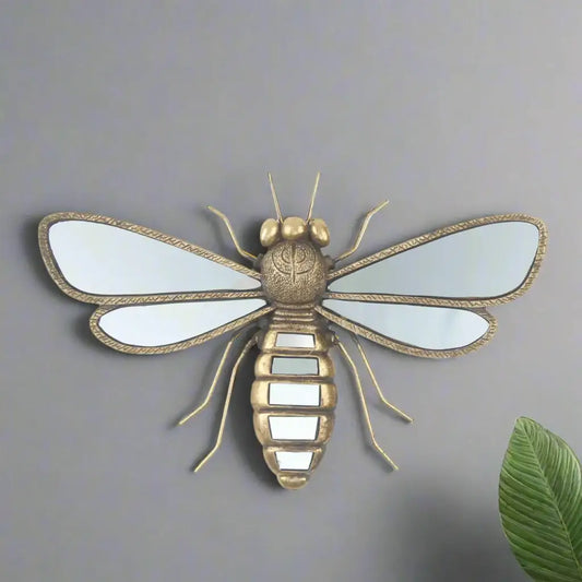 Decorative insect wall art with reflective wings on a white background