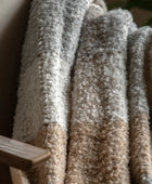 Close-up of carpet samples in various shades of brown and beige.