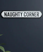 Decorative sign with 'NAUGHTY CORNER' text on a dark background