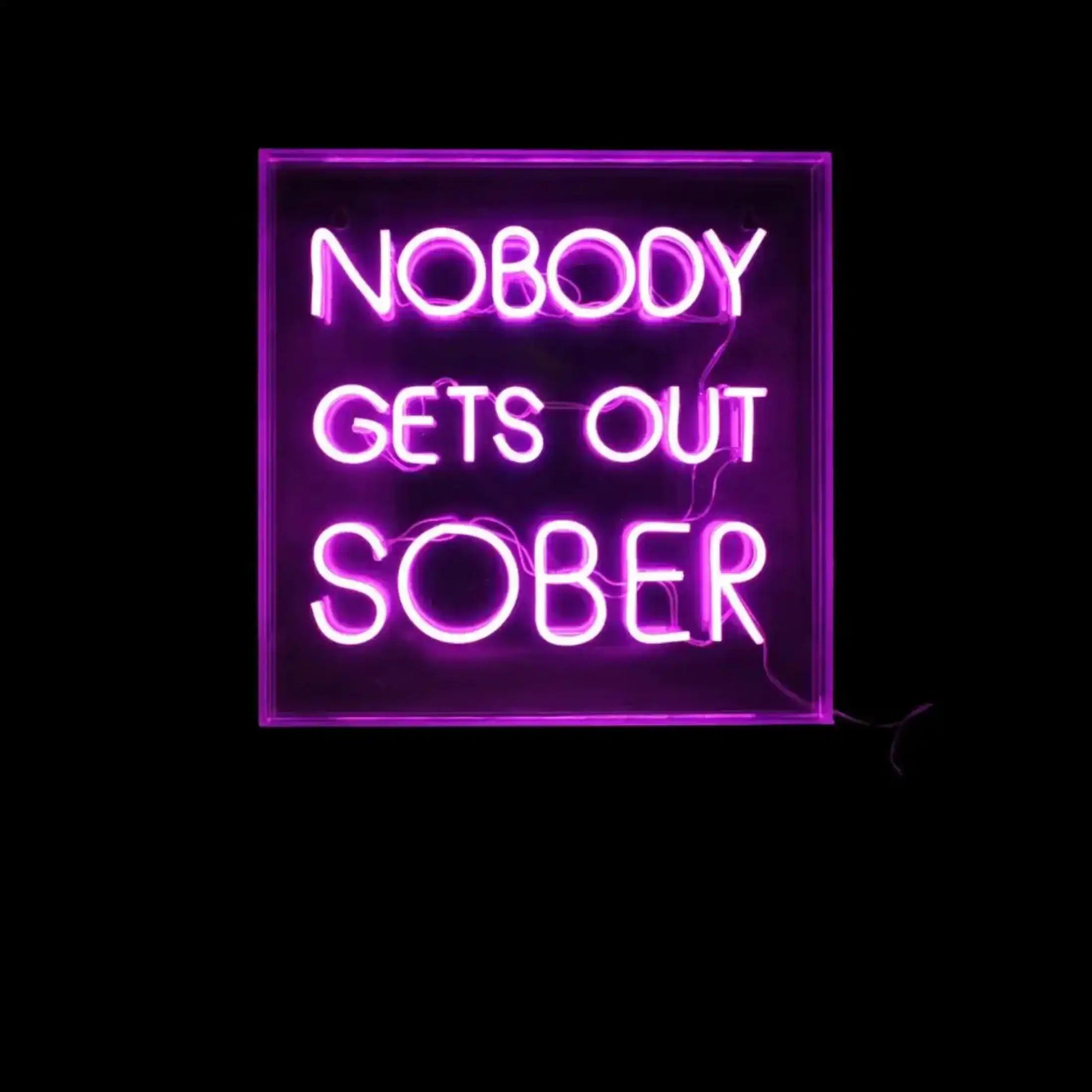Neon sign with the text 'NOBODY GETS OUT SOBER' on a black background