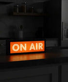 Digital sign displaying 'ON AIR' on a kitchen counter.
