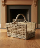 Wicker basket on a wooden floor in front of a fireplace