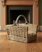 Wicker basket on a wooden floor with a fireplace in the background