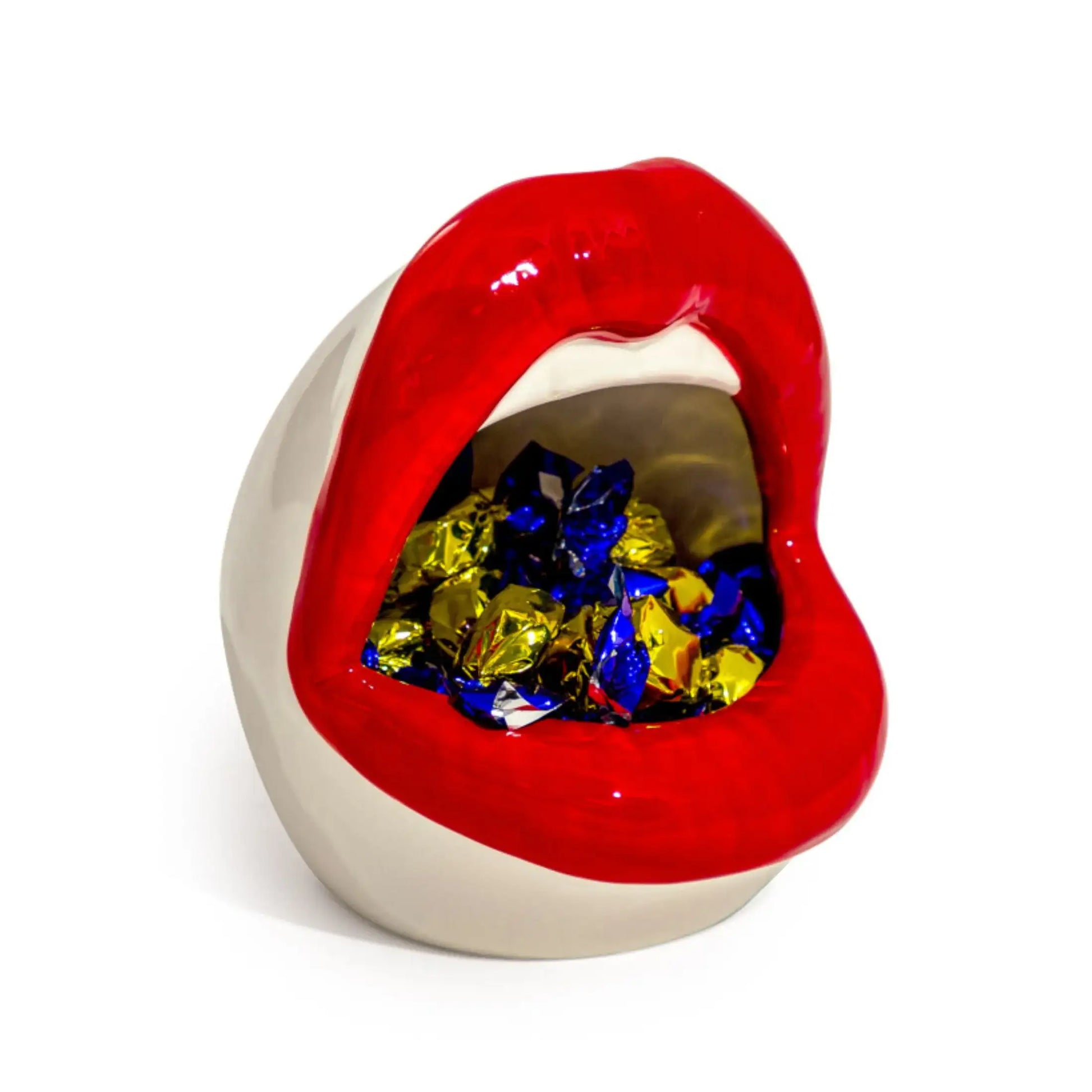 Lip-shaped container with colorful candies inside on a white background