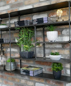 Metal shelving unit with decorative items against a brick wall