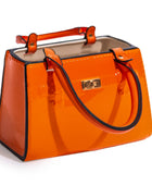 Orange handbag with black handle on a white background