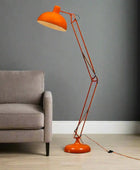 Orange floor lamp with adjustable arm on a white background