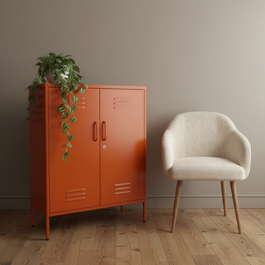 Orange cabinet with a plant next to a beige chair in a room with a wooden floor and gray walls.