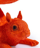 Close-up of a red squirrel toy on a white background