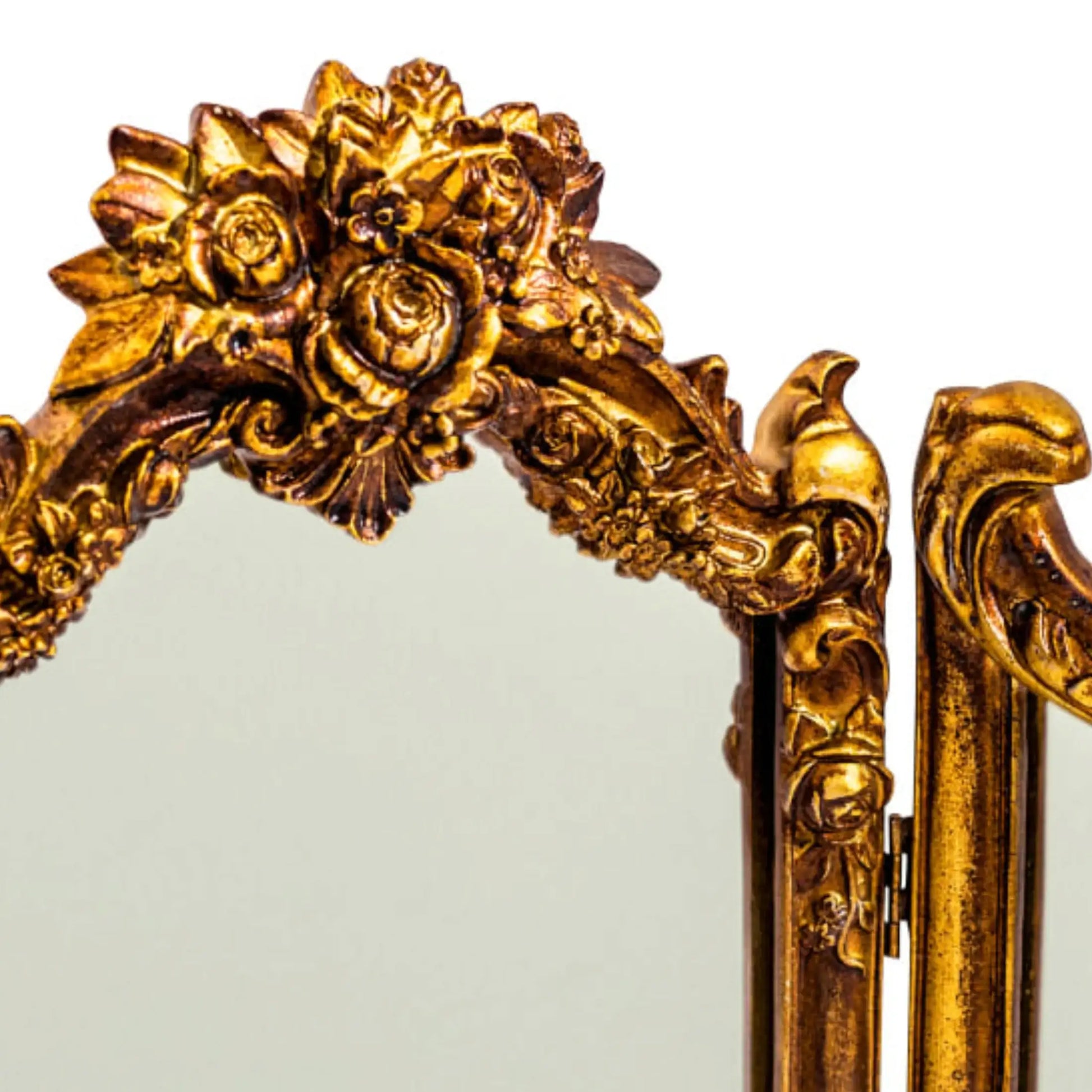 Decorative gold mirror with intricate floral designs on a white background