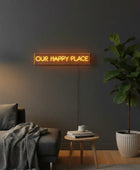 Neon sign with 'OUR HAPPY PLACE' text on a black background