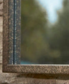 Close-up of a window frame with a blurred natural background