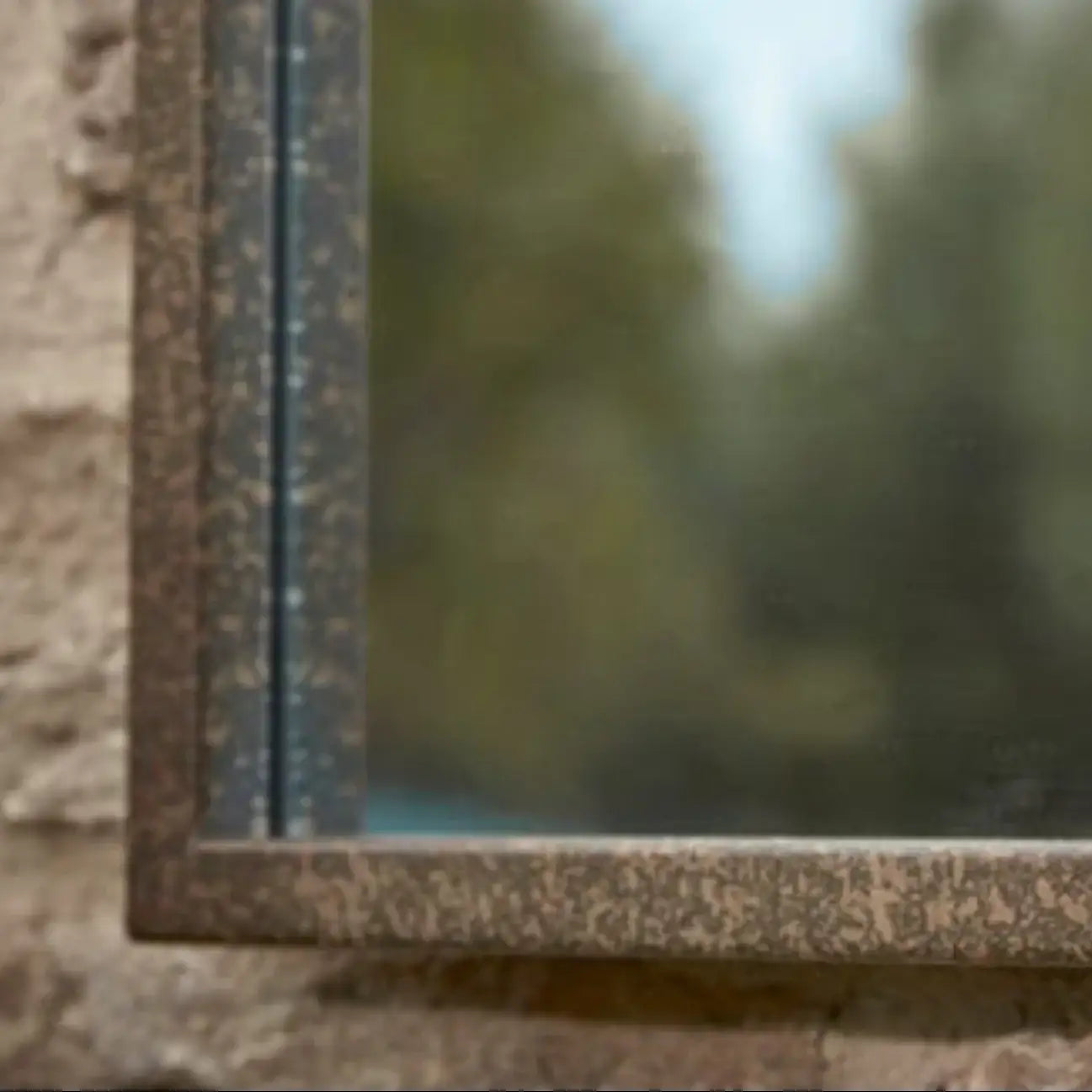 Close-up of a window frame with a blurred natural background