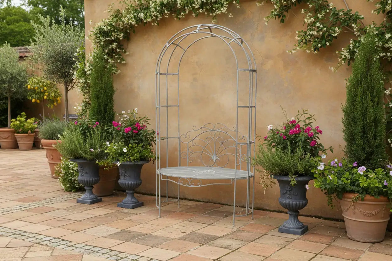 Decorative metal arch with potted plants against a wall with climbing plants