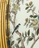 Decorative item with floral design and bird on a branch, gold frame on the left
