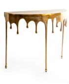Gold console table with a dripping design on a white background