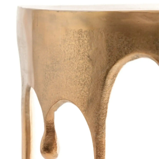Close-up of a textured gold stool on a white background