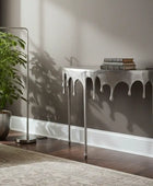 Modern living room with a gray sofa, console table, and plant.