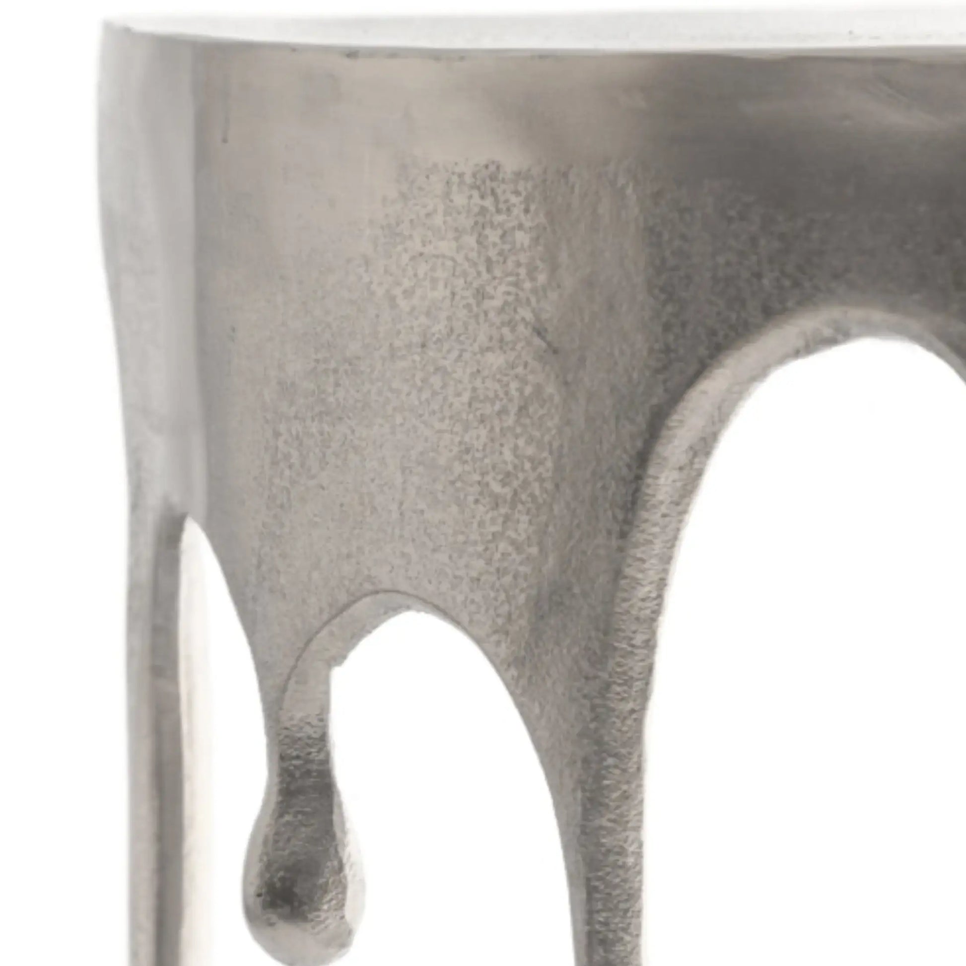 Close-up of a metallic object with a textured surface on a white background