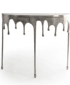 Metallic console table with a dripping design on a white background