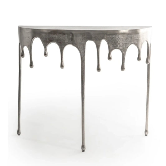 Metallic console table with a dripping design on a white background