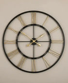 Decorative wall clock with black frame and gold Roman numerals on a white background